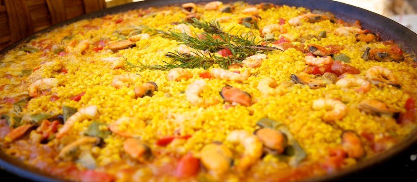 A mixed paella with chicken and seafood topped off with a few sprigs of rosemary.  Delicious!