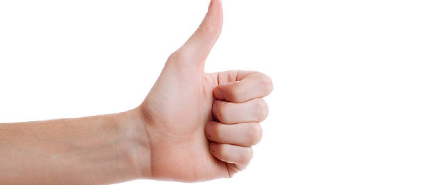Shot of hand making thumb up gesture on white background. Voting hand